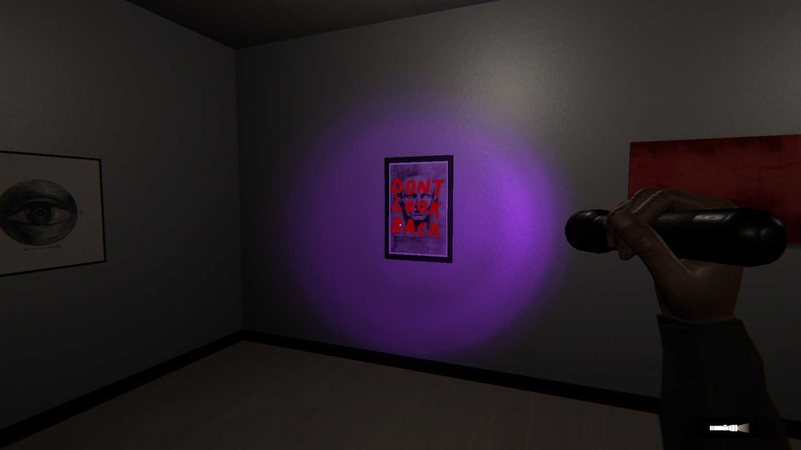 purple light from a flashlight highlights text on a wall portrait "DONT LOOK BACK"